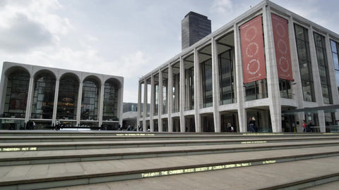 Lincoln Center in Manhattan - panning to African-American man alone on front steps in 4K and 1080 HD in NYC