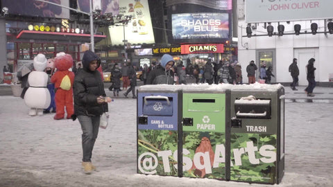 throwing trash in garbage in Times Square, snowing in winter at night - slow motion