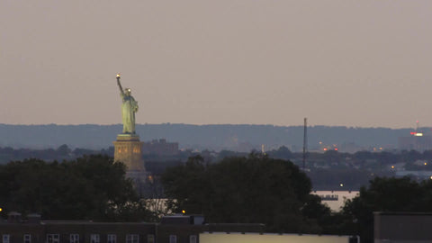 subway train leaving elevated station - Statue of Liberty in background - with audio in NYC
