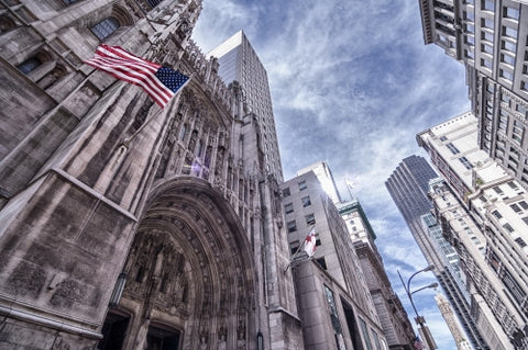 Saint Paul's Cathedral with American flag in Midtown Manhattan on sunny day in HDR