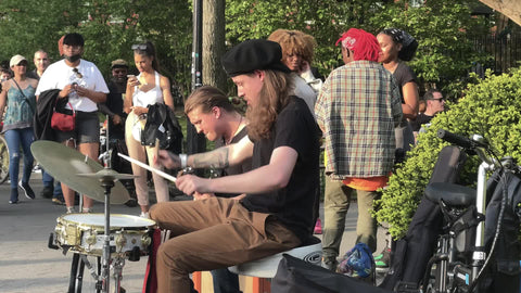 drummer doing drum roll solo band playing music in summer Washington Square Park NYC