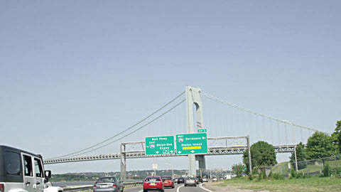 sign for Belt Parkway and BQE, Verrazano Bridge and Staten Island from moving car, driver's POV on highway