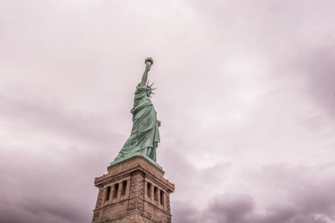 Statue of Liberty - full shot head to toe with base over pink cloudy sky