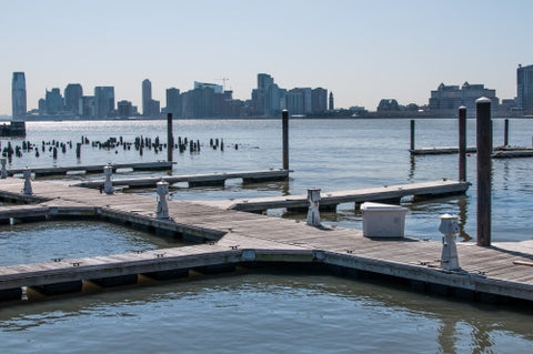 dock on East River with wood dowels and view of Queens in late afternoon day
