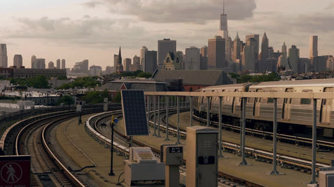 Brooklyn train departing from Smith and 9th st elevated subway station with Manhattan skyline in background in 4K and 1080 HD