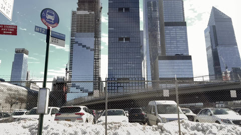Hudson Yards West Side Highway skyscrapers parking lot fence with snow in winter Manhattan New York City NYC