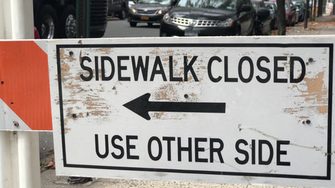 sidewalk closed use other side construction sign oneway arrow in Manhattan New York City NYC