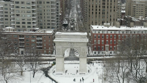 aerial flyover over Washington Square Park arch in cold winter Manhattan New York City NYC