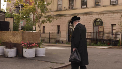 elderly Orthodox Jewish man walking down street in Williamsburg Brooklyn on Fall day in NYC
