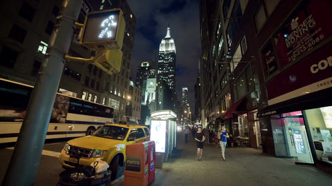 Empire State Building wide angle walk sign on 5th Ave at night in Manhattan