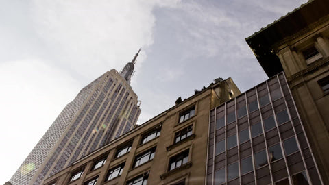 towering Empire State Building from moving view - famous skyscraper in Manhattan New York City