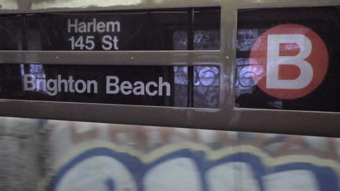 sign for B train, Harlem 145th St and Brighton Beach in Brooklyn, moving train with window, gritty New York City