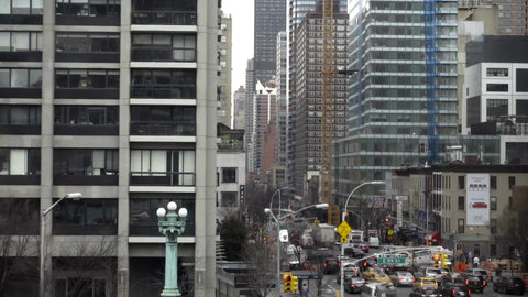 buildings on East Side of Manhattan moving overhead with busy street below in 1080 HD in NYC