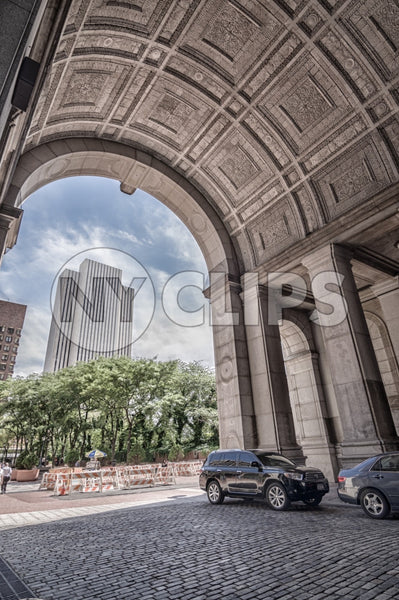 Manhattan Municipal Building arch in Downtown with cobblestone street in NYC