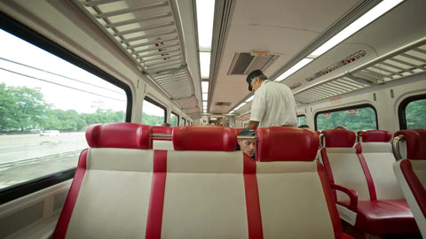 conductor punching tickets on Metro North - interior train in NYC