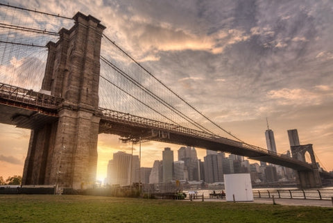Brooklyn Bridge Park with Manhattan skyline across East River and beautiful orange sunset in NYC
