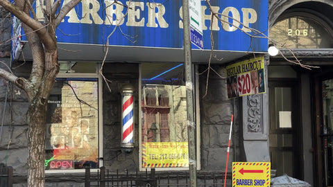 barber shop front door entrance exterior with spinning red white and blue pole Upper West Side New York City NYC