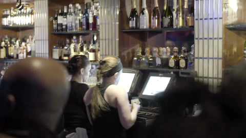 bartender working computer and register in night club - holding cash - getting frustrated