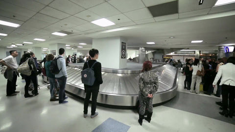 people waiting for bags at LaGuardia Airport baggage claim conveyor belt