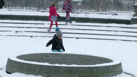 boy in snow - snowing in Washington Square Park circle in winter blizzard - boy standing and staring in the cold - New York City NYC - slow motion 4K and 1080 HD
