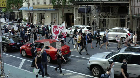 Black Lives Matter march side view 5th Avenue with stop Trump sign in Manhattan New York City NYC