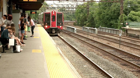 Metro North arriving at station on elevated station track in NYC