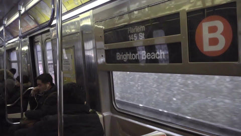 B train interior - Harlem and Brighton Beach sign with passengers sitting by window, riding in 1080 HD in NYC