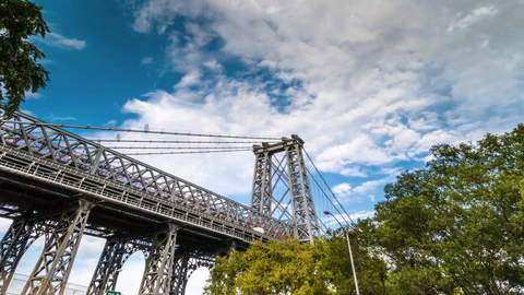 Williamsburg Bridge during the day - 4K timelapse in HDR tilting down to cars driving on highway
