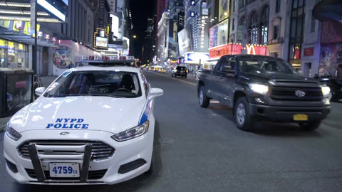 police car parked on the street at night off Times Square