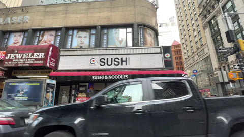 driving past sushi and pizza restaurants in Financial District Downtown Manhattan New York City NYC