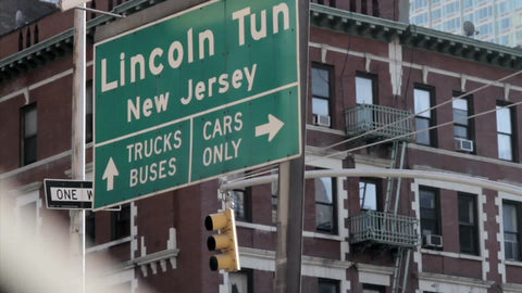 Lincoln Tunnel sign to New Jersey - trucks buses, cars only arrows - close-up in NYC