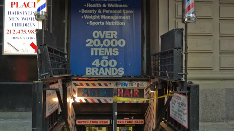 Astor Hair sign - famous barbershop staircase leading downstairs in summer during day, Greenwich Village Manhattan NYC