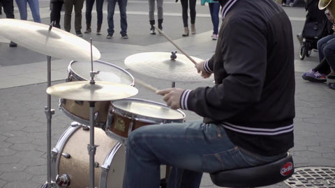 man playing drums in Washington Square Park - drummer in winter on cold day in 4K and 1080 HD NYC