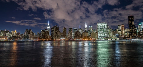 Manhattan skyline in evening with famous skyscrapers and landmarks: Empire State Building, Chrysler, United Nations and East River water