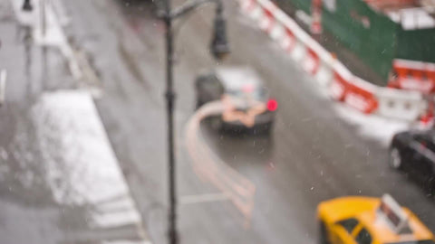 taxi cab driving down street snowing in winter over holidays