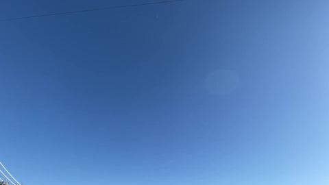 Brooklyn Bridge and Manhattan Bridge tilting down from sky to East River water waves in New York City NYC