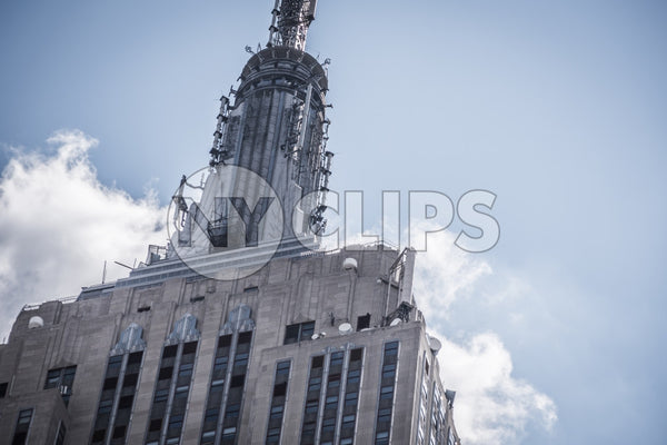 tight close-up shot of top of Empire State Building on grey hazy day