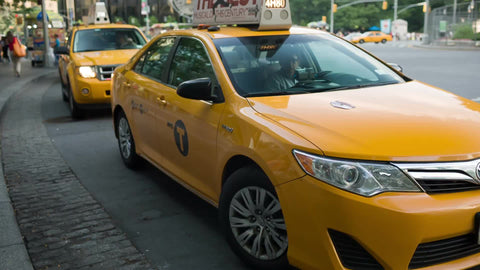 family getting into taxi cab on summer day at Columbus Circle Manhattan NYC