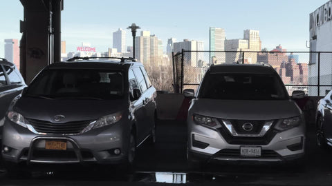 driving past parked cars by gritty warehouse on pier 17 East River in Lower East Side LES Manhattan New York City NYC