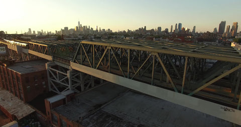 subway trains on bridge Manhattan skyline NYC