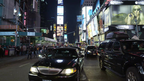 Uber limousine car driving in Times Square at night in NYC