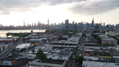 aerial over Greenpoint Brooklyn moving toward Manhattan skyline NYC