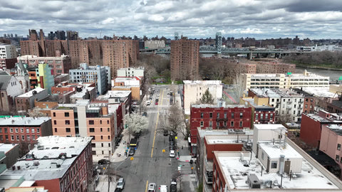 aerial moving over track court toward housing projects in East Harlem NYC