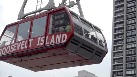 Roosevelt Island tram moving overhead - closeup of red carriage in air in 1080 HD in NYC
