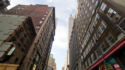 driving past FedEx truck with Empire State Building towering over street