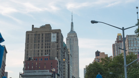 pulling out slowly from Empire State Building 4K timelapse day to night lighting up in Manhattan New York City