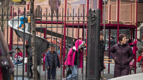 Asian-American kids playing in Chinatown playground - Chinese parents with their children