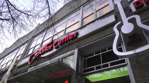 Guitar Center music store entrance on 14th St in winter panning across sign NYC