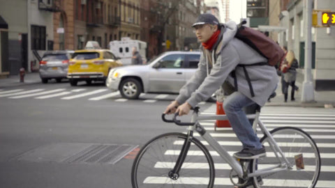 man on bicycle riding in Chelsea on fall day in Manhattan NYC