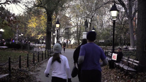 joggers in Washington Square Park on beautiful autumn day in slow motion